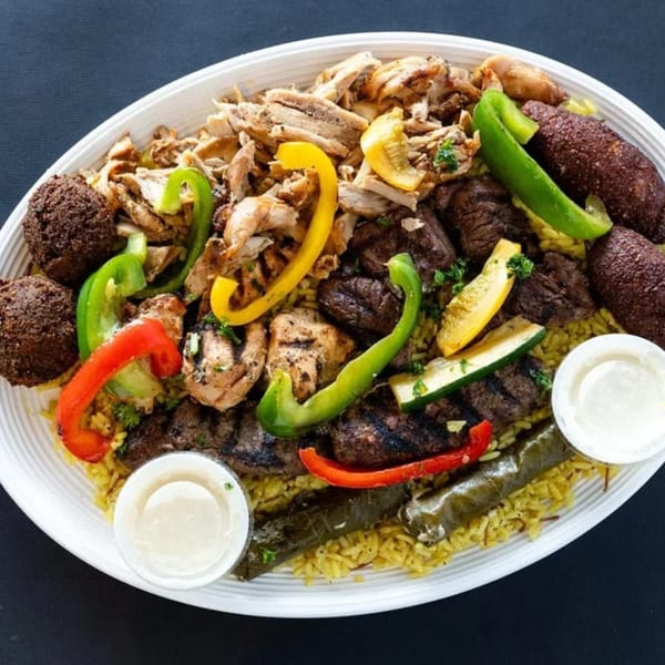 Sultan's Restaurant's large platter of Mediterranean food with rice, meats, falafel, and vegetables.